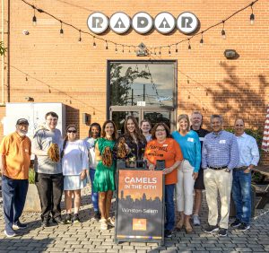 A group of Campbell alumni posing for a photo outside of Radar Brewing